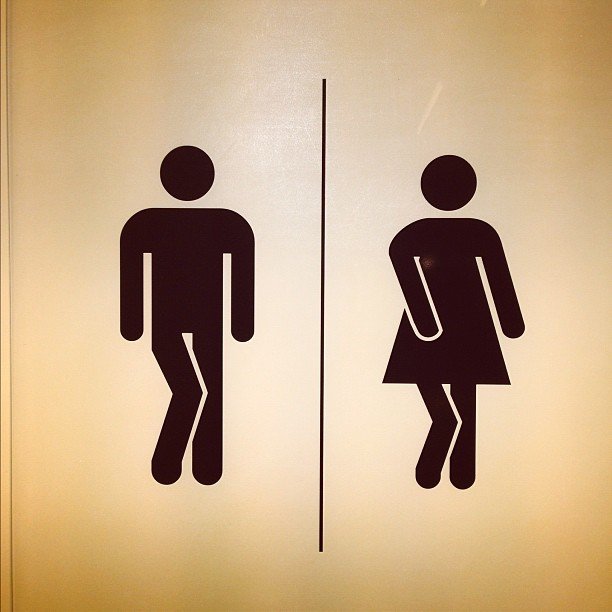 Silhouette of male and female with legs crossed like they need to pee